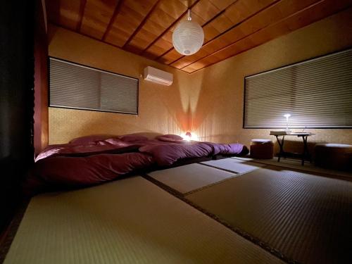 a bedroom with a bed in the corner of a room at Airportside Chillhouse in Toyonaka