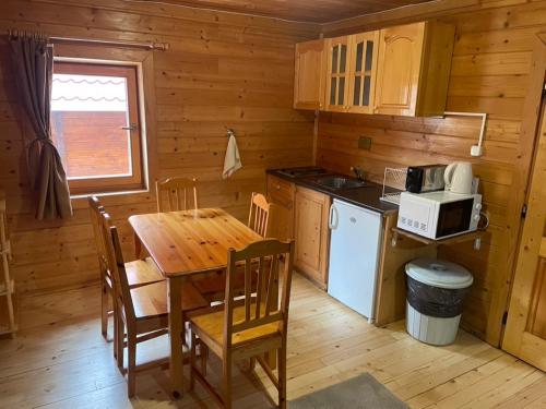 a kitchen and dining room with a table and a microwave at Chalet Sofia in Borovets