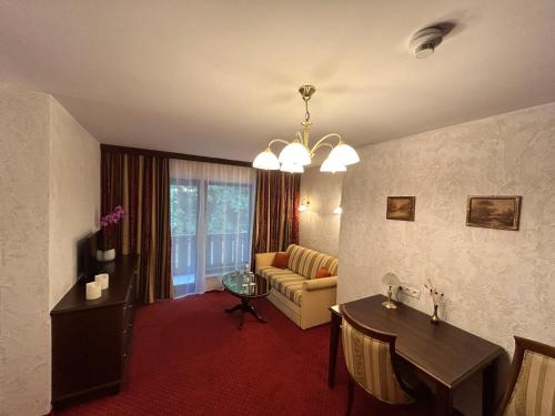 a living room with a couch and a table at Hotel-Restaurant Batzenhäusl in Innsbruck