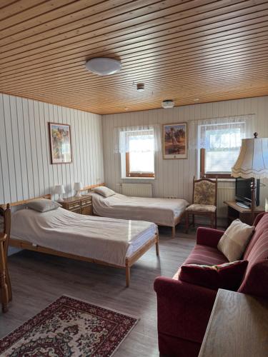 a living room with two beds and a couch at Weesby Süderstraße 3.3 in Weesby