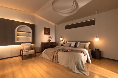 a bedroom with a large bed and a chair at Shangri La Yi Shan Ban Yun Inn in Shangri-La