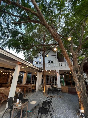 a patio with tables and chairs and a building at Hotel Nanon Sathorn in Bangkok