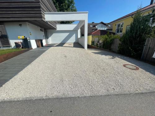 a driveway in front of a house with a white structure at Amt11 - Relax / family / home-office in Bad Wörishofen