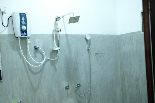 a shower in a bathroom with a shower at AQUARIUS Stay in Tangalle