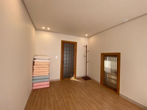 a room with white walls and wooden floors at Bonjour Hanok in Gyeongju