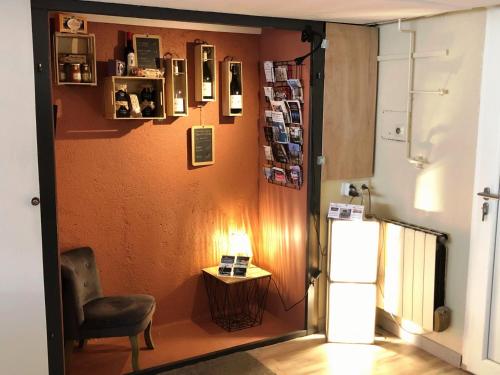 a living room with a chair and a refrigerator at Chambres d'Hôte Dijon Clair de Lune Adults Only in Chenôve