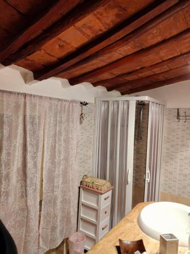 a bathroom with a sink and a wooden ceiling at La Dimora del 1700 in Tivoli