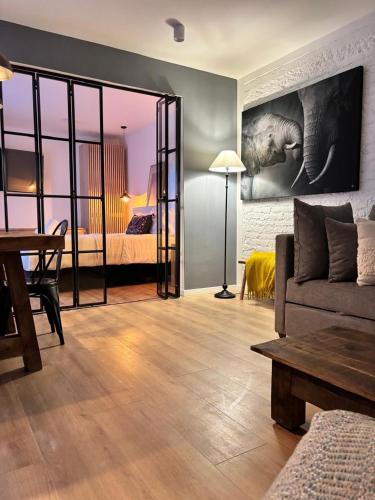 a living room with a couch and a bedroom at Bright & sweet unit in the heart of Polanco. in Mexico City