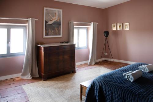 a living room with a couch and two windows at Le Domaine de Villespy in Villespy