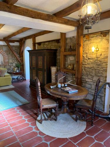 a dining room with a wooden table and chairs at Sokograd Royal in Šipovo