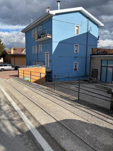 a blue building on the side of a street at Il Vespro Apartment in Montegiorgio