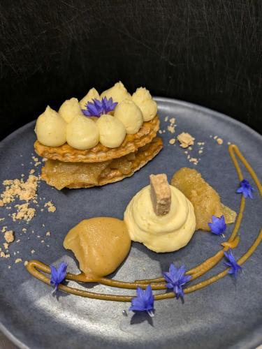 a plate with three deserts with blue flowers on it at Le Derrien in La Roche-Derrien