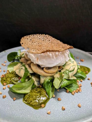 a plate of food with a sandwich on top at Le Derrien in La Roche-Derrien