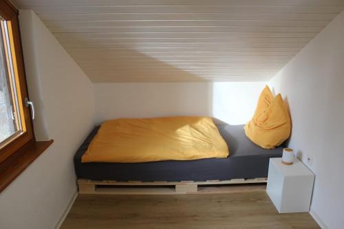 a bed in a small room with a ceiling at Naturzauber in Sonnenbühl