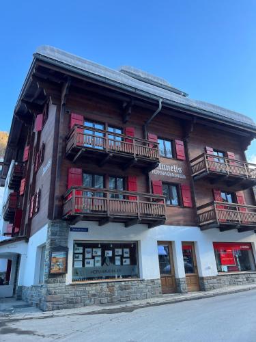 a building with balconies on the side of it at Chalet Annelis Apartments in Zermatt