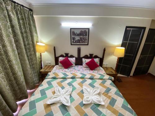a bedroom with a bed with bows on it at Hotel Signature Villa in Jodhpur
