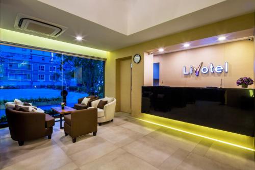 a living room with a lobby with a hotel at Livotel Hotel Kaset Nawamin Bangkok in Bangkok