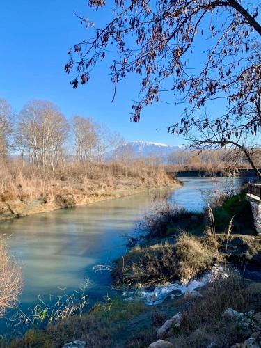 a river with a bridge in the background at Guesthouse RAMAJ in Perondi
