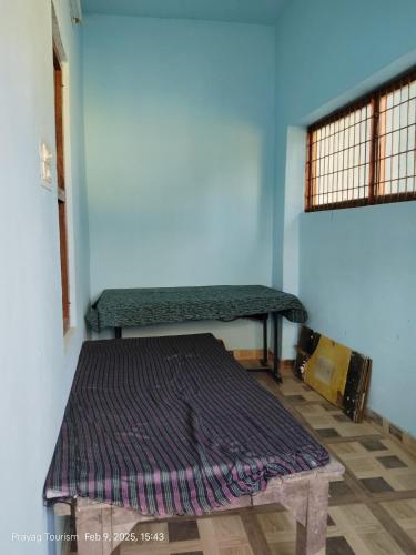 Ένα ή περισσότερα κρεβάτια σε δωμάτιο στο Triveni Sangam Apartment