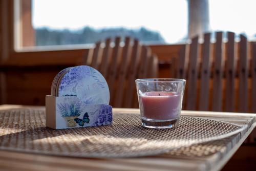 a glass of water and a candle on a table at Vikendica Rile in Sekulić 