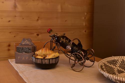 a bottle of wine and a basket of bread on a table at Vikendica Rile in Sekulić 