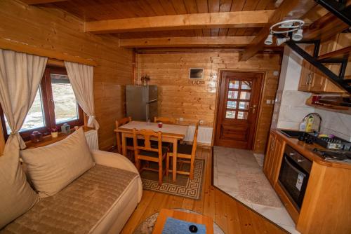 a living room with a couch and a table at Vikendica Rile in Sekulić 
