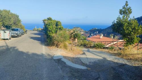 a road with cars parked on the side of the road at Isola del Giglio casa Nico e casa Camilla Monticello Giglio Porto in Isola del Giglio