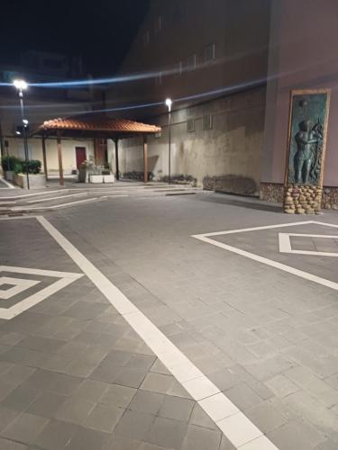 an empty parking lot at night with a statue at Borgo Marino casa vacanze in Santa Teresa di Riva