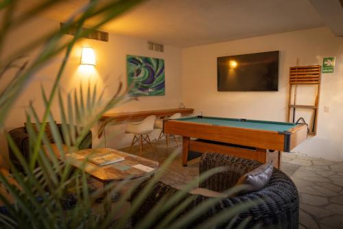 a living room with a pool table and a couch at Soleil Bungalows in Los Órganos