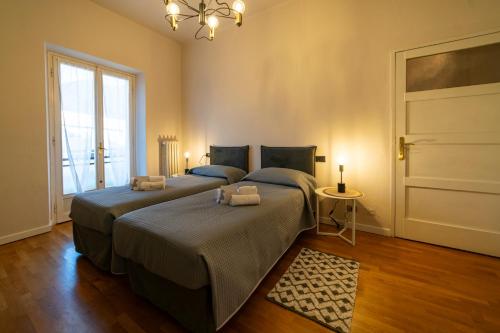 a bedroom with two beds and a window at Business House in Costa Volpino