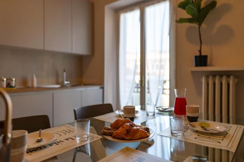 a kitchen with a table with a plate of food on it at Business House in Costa Volpino