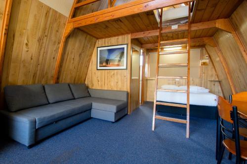 a small room with a couch and a bunk bed at Discovery Parks - Boulder in Boulder