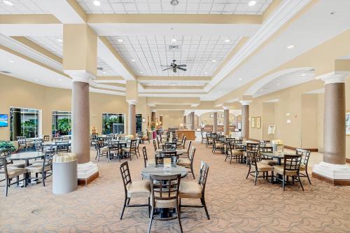 a large dining room with tables and chairs at Disney Accessibility Star Wars Vacation Apartment Near Parks in Orlando