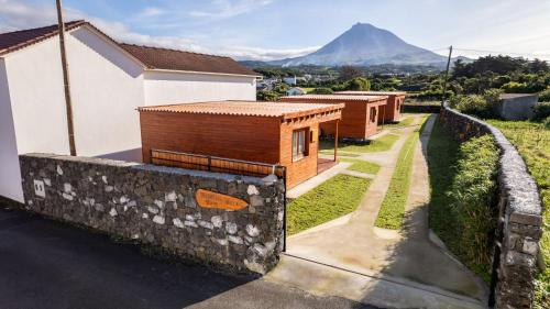a row of buildings with a mountain in the background at Mountain Wood Village in Madalena