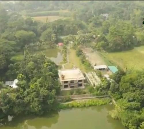 an aerial view of a house in the middle of a river at Farm House in Muksūdpur