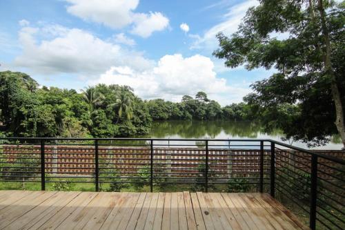 a wooden deck with a view of a lake at Farm House in Muksūdpur