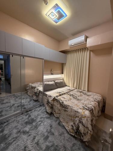 a bedroom with two beds in a room at Glamorous SMDC Shore 3, 5 Star Rate BnB-Wifi-Netflix in Manila