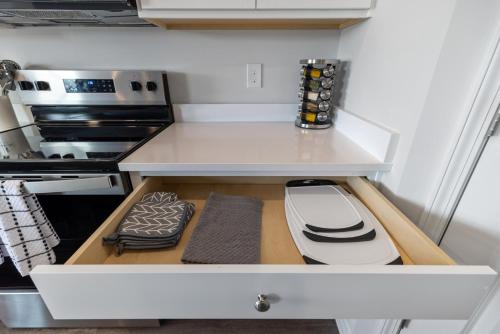 a kitchen with a white counter top with a drawer at Luxury 5BR Home Minutes from Wilmington Beaches in Scotts Hill
