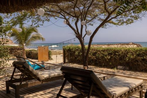 two chairs and a table on a beach at Soleil Bungalows in Los Órganos