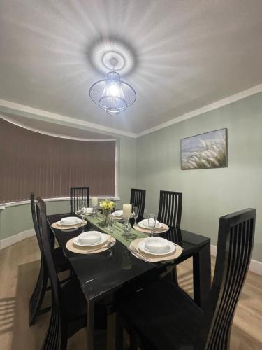 a dining room with a black table and chairs at House 246 in Birmingham