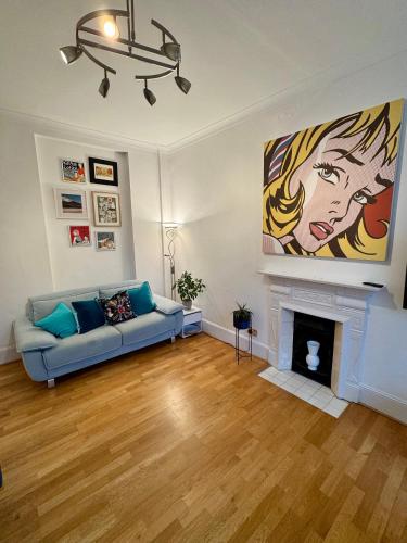 a living room with a couch and a fireplace at Amazing holidays home with a terrace in London