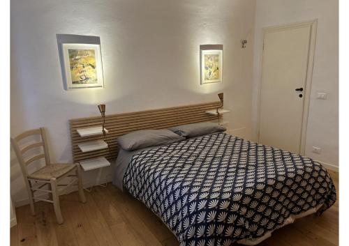 a bedroom with a bed and a chair in it at Frescos house in Pisa