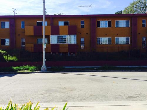 an orange building with a pole in front of it at Relax Inn in Los Angeles