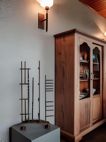 a room with a table and a shelf and a cabinet at Pousada Borghetto – Charme e Exclusividade no Vale dos Vinhedos in Bento Gonçalves