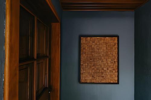 a room with a brick wall and a window at Pousada Borghetto – Charme e Exclusividade no Vale dos Vinhedos in Bento Gonçalves