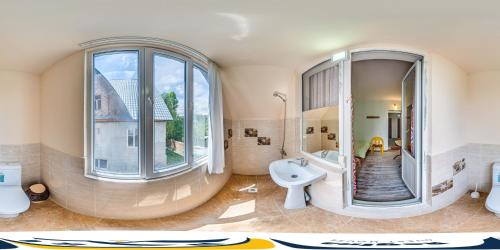 a large bathroom with a sink and a mirror at Guest House Regina in Bulan Sogottuu