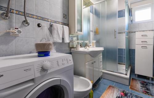 a bathroom with a washing machine and a sink at 1 Bedroom Lovely Apartment In Ploce in Ploče