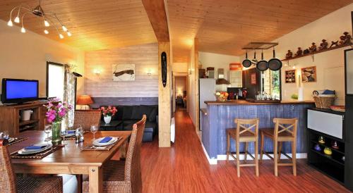 une salle à manger et une cuisine avec une table et des chaises dans l'établissement Maison - piscine - Vue vignobles coeur de nature, à Roquetaillade