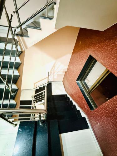 a spiral staircase in a building with a window at Vrindas Home Stay in Maheshwar