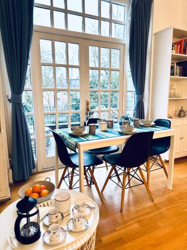 a dining room with a table and chairs at Amazing holidays home with a terrace in London
